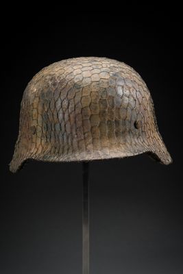 a close up of a helmet on a stand against a black background