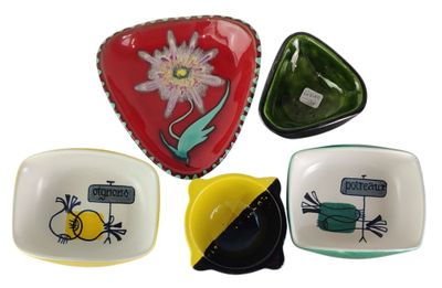 four plates with different designs on them on a white background