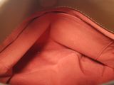 a close up of a purse with a red cloth inside of it