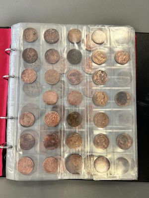 an open book with a bunch of coins in it sitting on a table