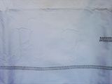 a piece of white fabric with a monogram on it
