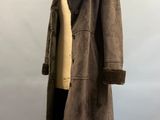 an image of a mannequin wearing a brown coat and sweater