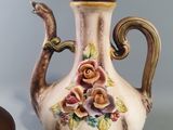 a picture of a tea pot with a rose design on it next to other teapots