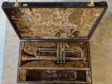 an old trumpet in a case on the floor