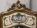 a mirror with a gold frame and a blue and white picture on it