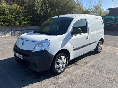 the small white van is parked in the parking lot