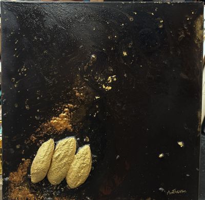 a picture of a black and gold painting on a table