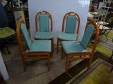 four chairs with blue upholstered seats in a room with a rug