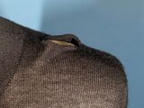a close up of a brown sweater with buttons on it