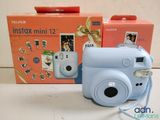 a blue camera and a pink box on a table