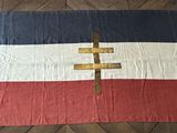 a bed with a red, white, and blue blanket on it