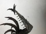 a sculpture of a bird made of metal on a table
