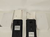 two cell phones that are sitting on a table