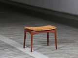 a small wooden stool sitting on the floor in a room