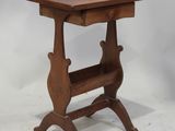 an old wooden side table with a shelf on it