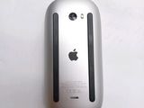 a close up of an apple mouse on a white surface