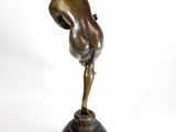bronze statue of a man standing on a pedestal with his arms outstretched