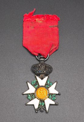 a close up of a medal with a red ribbon on a table
