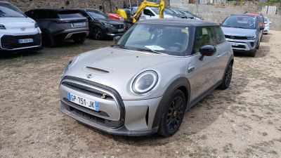 a silver mini cooper parked in a parking lot