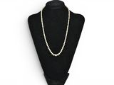 a black mannequin with a white pearl necklace on it