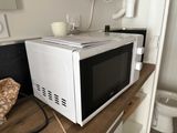a microwave sitting on top of a counter in a kitchen