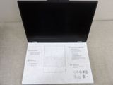 a laptop computer sitting on a table with instructions on it