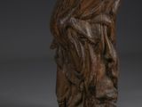 a wooden statue of a woman holding a child