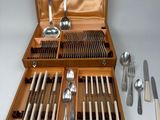 a wooden case with silverware in it on a table