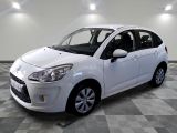 a picture of a white car parked in a garage