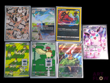 a lot of pokemon cards that are on the table