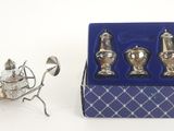 a miniature carriage with silverware in it and a blue box on the table