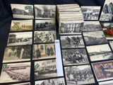 a lot of old black and white photos on the table