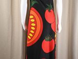 a mannequin wearing a dress with tomatoes and tomatoes on it