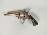 a close up of a small revolver on a white surface