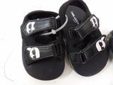 a pair of black sandals with white letters on them