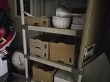 many boxes and boxes on a shelf in a room