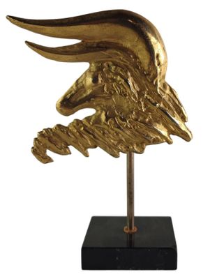 sculpture of a golden eagle head on a black marble base