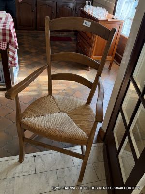 a person standing in a kitchen with a table and chairs
