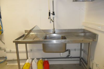 a stainless steel sink in a small kitchen