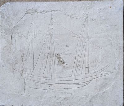 a picture of a stone plaque with a boat on it