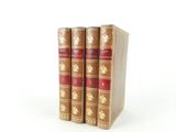 three books sitting on top of each other on a white surface