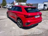 the rear end of a red audi car parked in a parking lot