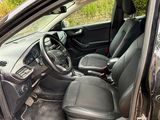 the interior of a car with the door open showing the driver ' s seat area