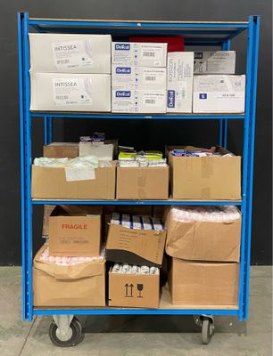 un chariot bleu chargé de cartons, les uns sur les autres