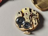 a close up of a watch movement on a table