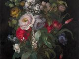 flowers in a glass vase on a table with a black background