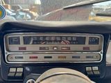 a dashboard of a car with a speedometer and a steering wheel