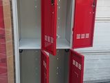 two red metal lockers are stacked on pallets in a warehouse