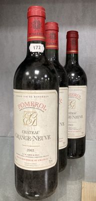 three bottles of wine sitting on a glass table