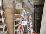 a ladder that is leaning against a wall with a number on it